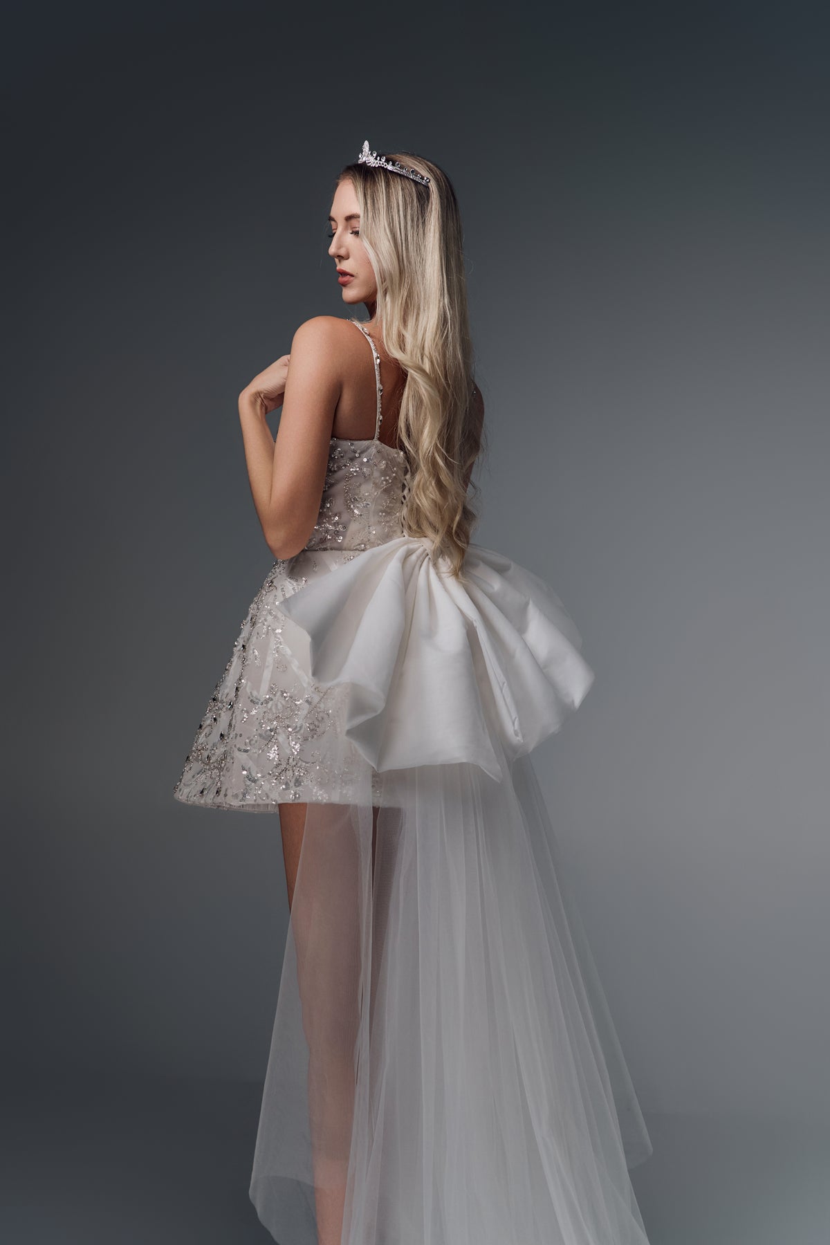 Allegra beaded mini wedding dress with satin bow train, back view