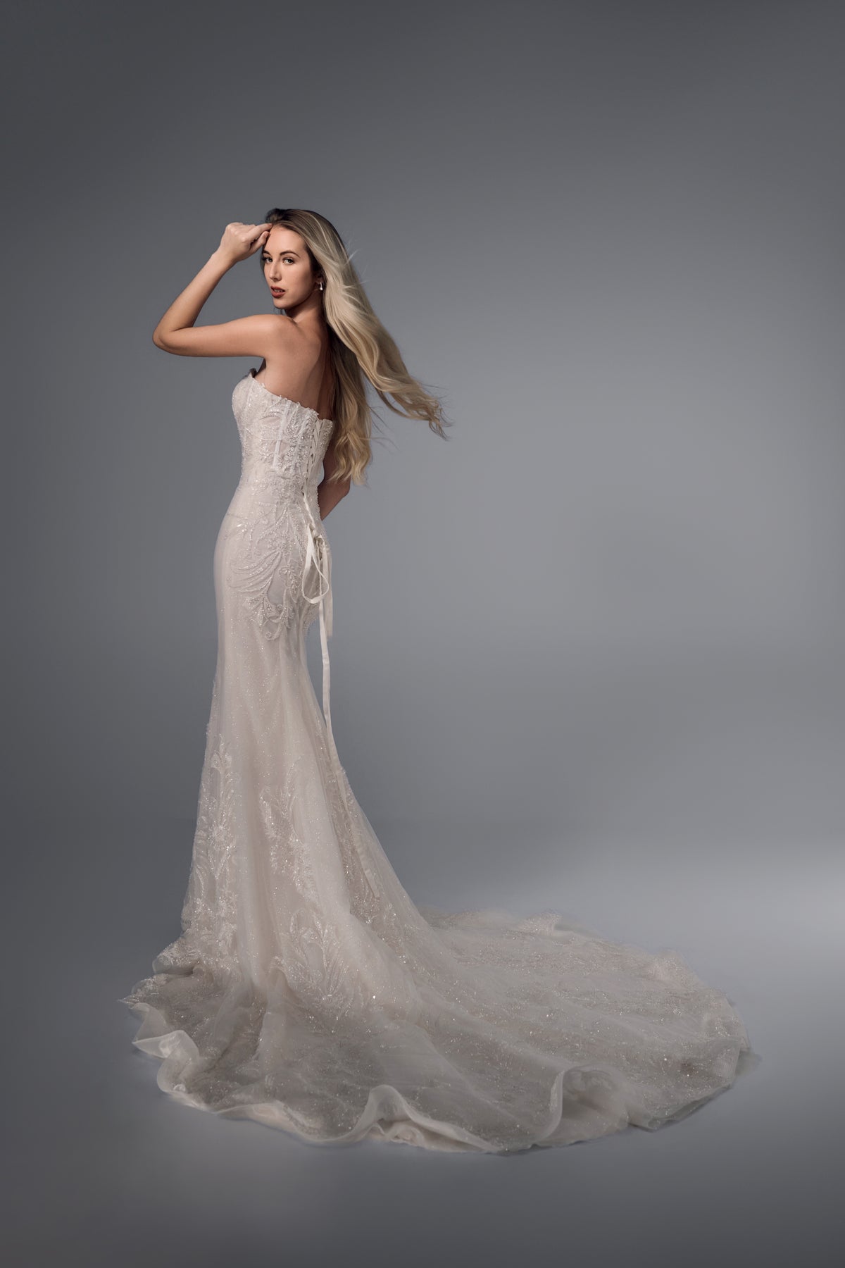 Corisande fitted beaded lace mermaid wedding dress, side view
