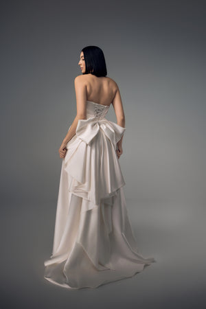 Cyrene minimal satin column wedding dress with sculptural bow back, back view