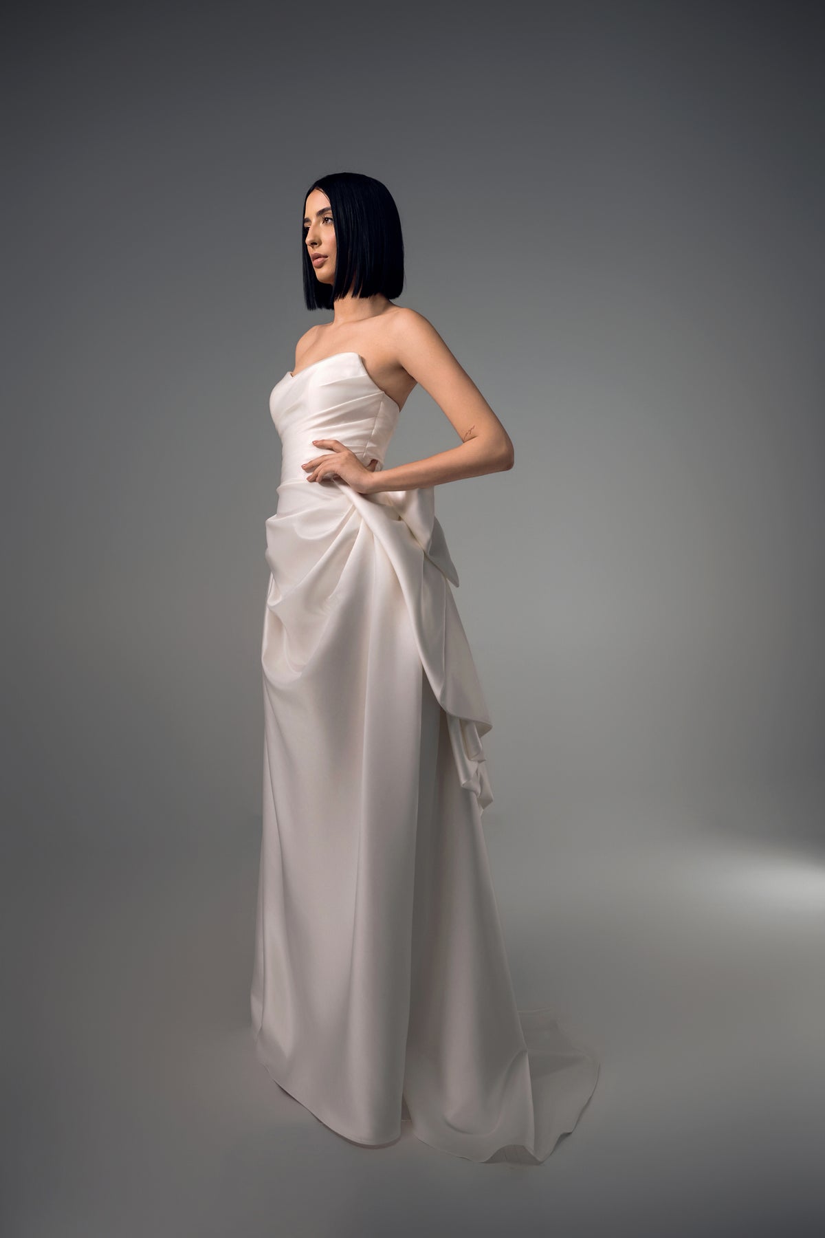 Cyrene minimal satin column wedding dress with sculptural bow back, side view