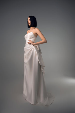 Cyrene minimal satin column wedding dress with sculptural bow back, side view