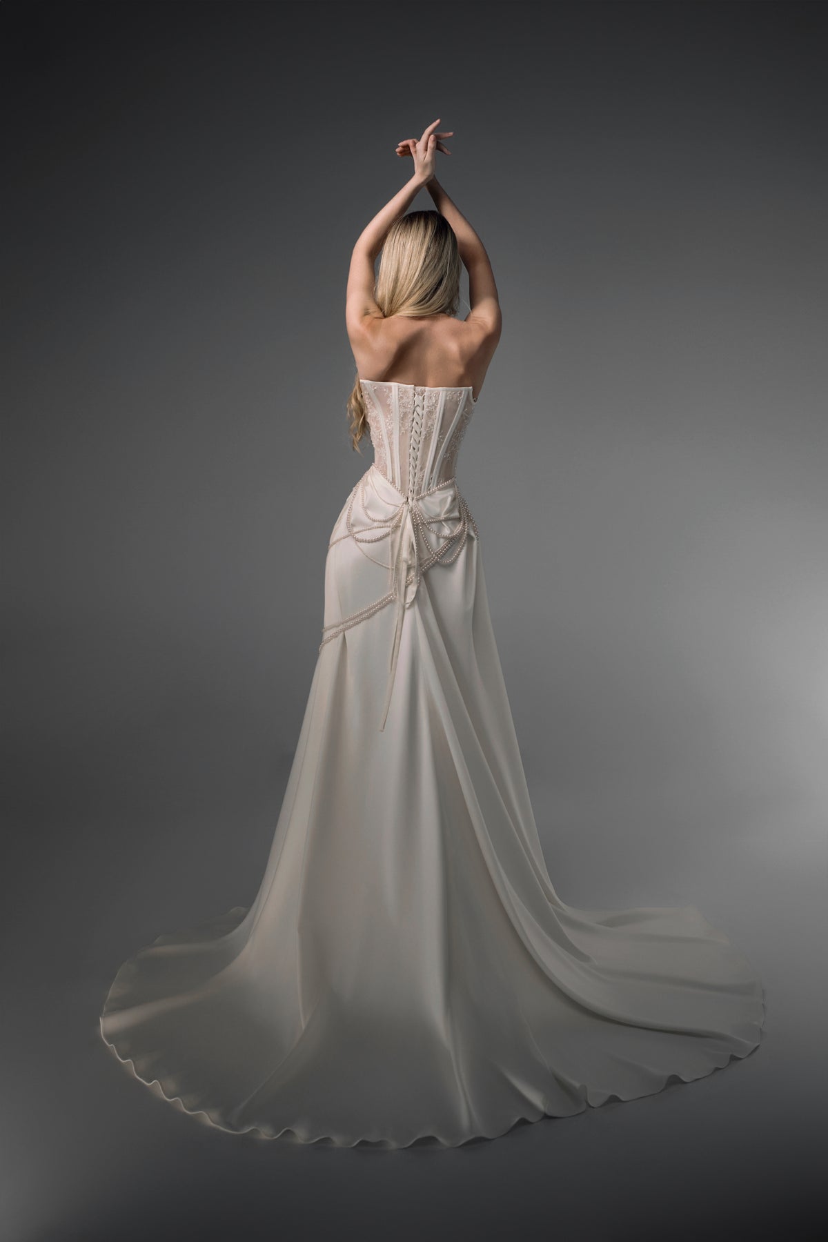Isabeau sheer-corset draped satin mermaid wedding dress, back train view