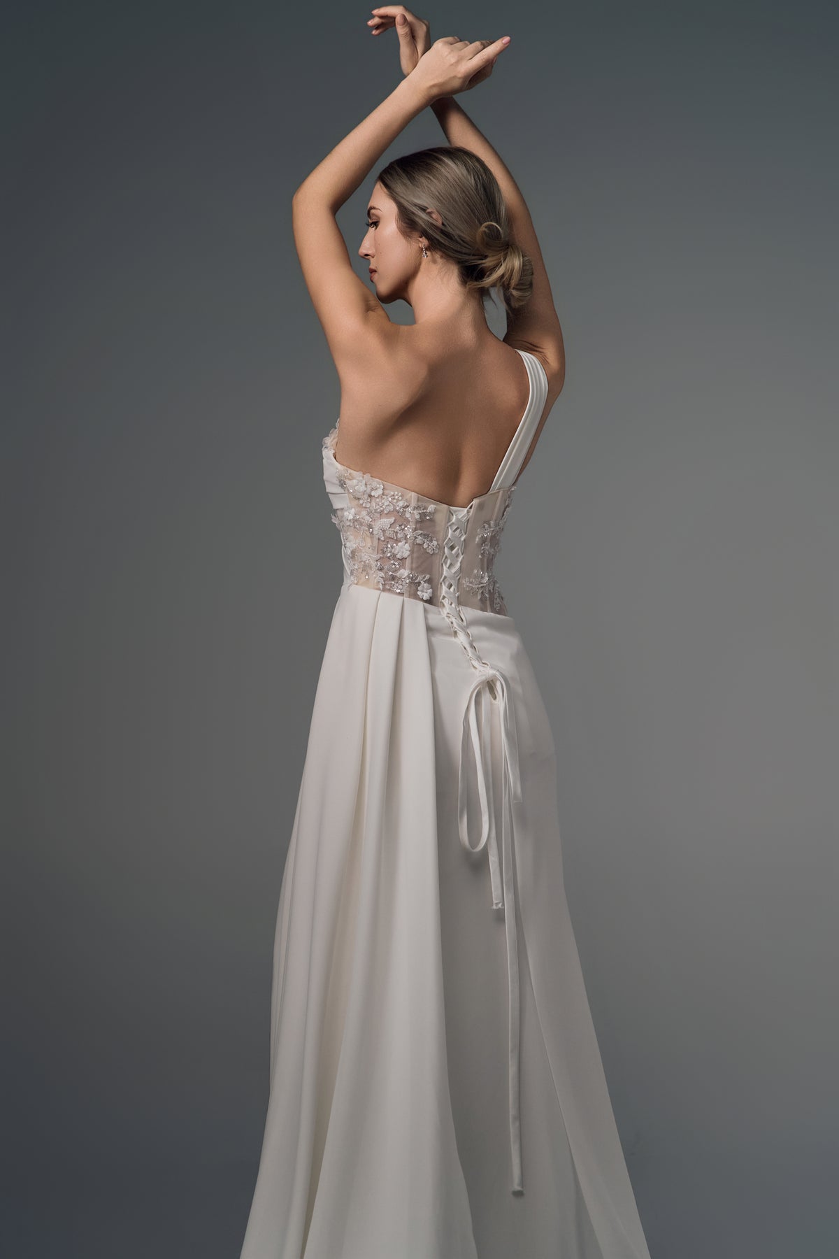 Leontine asymmetric satin wedding dress, open lace-up back view