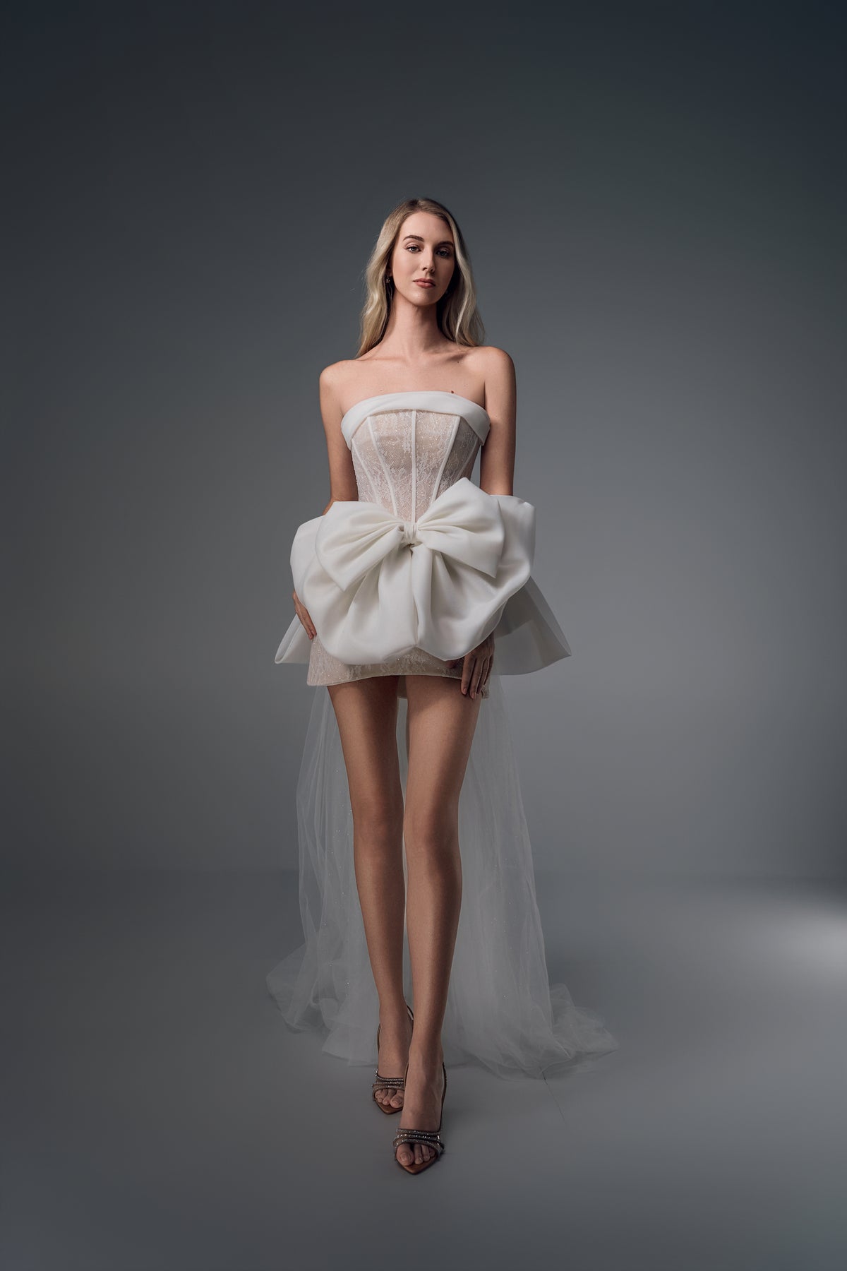 Novella sheer-bodice mini wedding dress with bow train, front view
