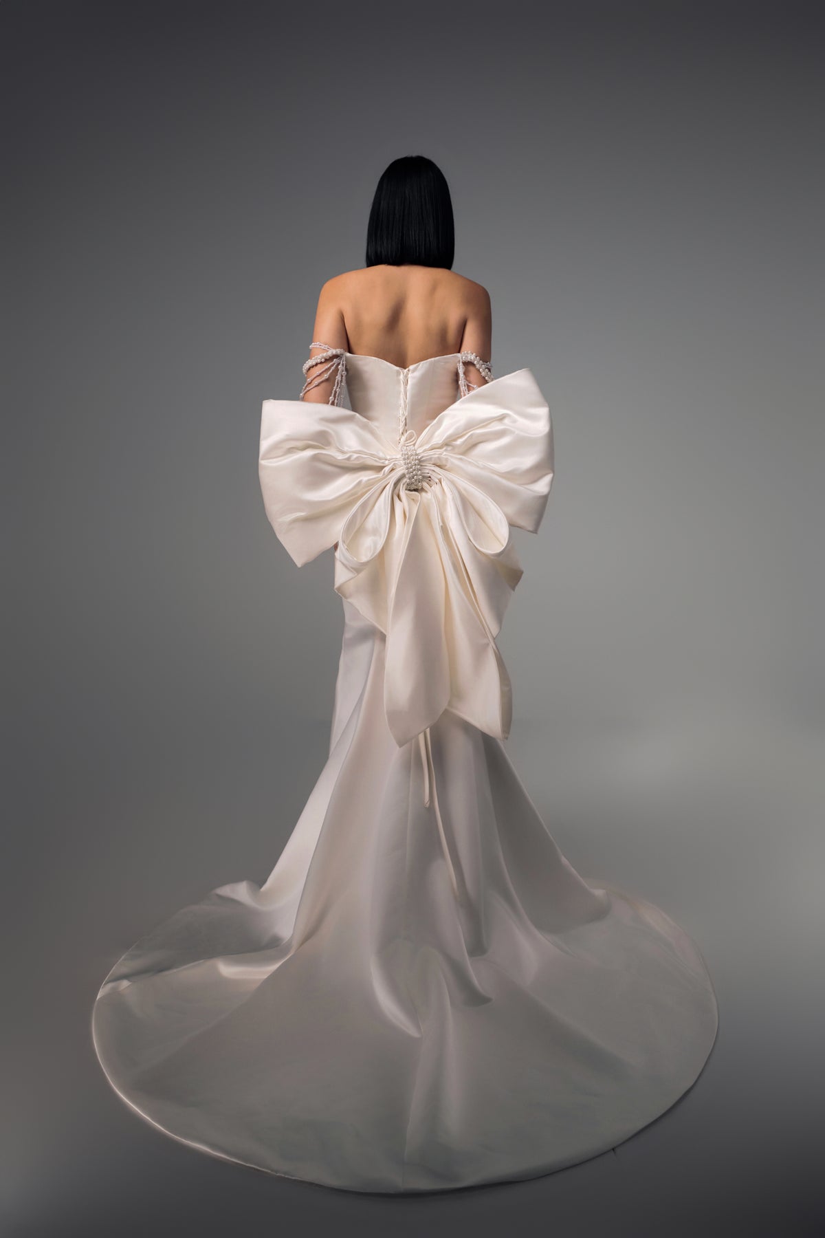 Sidonie wedding dress with oversized sculptural satin bow, back view
